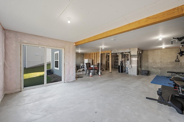 below grade area with heating unit and freestanding refrigerator