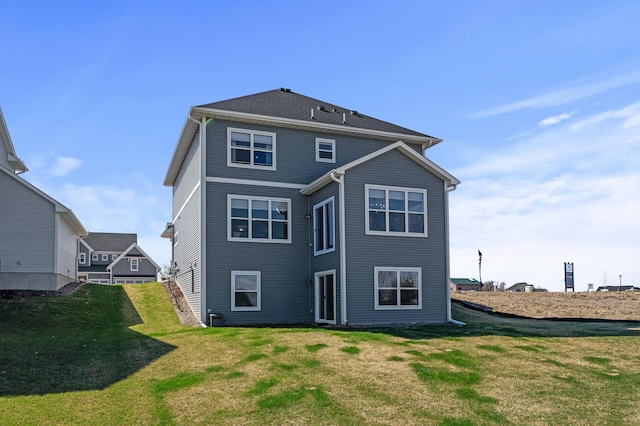 rear view of property with a yard
