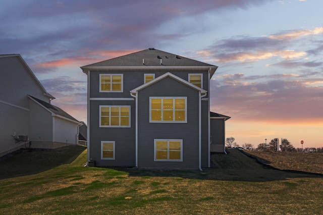 back of house featuring a yard