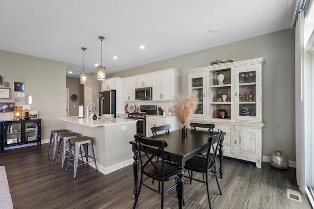 3459 109th Ln NE, Blaine, MN 55449 - dining area featuring dark wood finished floors, baseboards, and recessed lighting