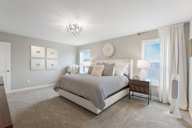 3459 109th Ln NE, Blaine, MN 55449 - bedroom with carpet, baseboards, and a chandelier