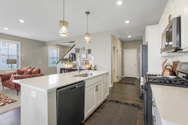 3459 109th Ln NE, Blaine, MN 55449 - kitchen with stainless steel appliances, a sink, open floor plan, dark wood-style flooring, and light countertops