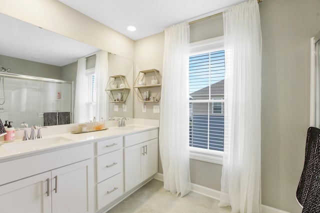 3459 109th Ln NE, Blaine, MN 55449 - full bath with double vanity, an enclosed shower, and baseboards