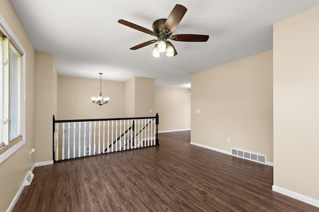 15320 90th St NE, Otsego, MN 55330 - empty room with a chandelier, dark wood finished floors, and ceiling fan
