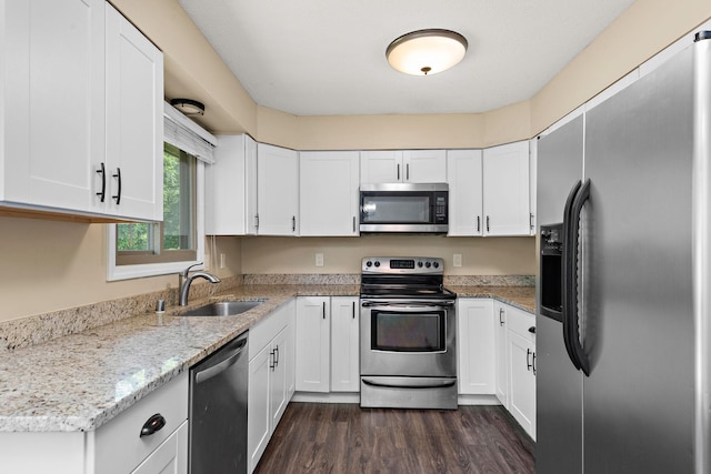 15320 90th St NE, Otsego, MN 55330 - kitchen featuring stainless steel appliances, dark wood-type flooring, white cabinetry, and light stone countertops