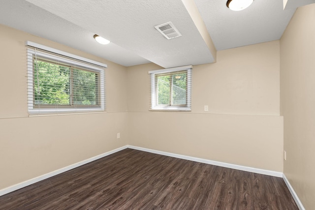 15320 90th St NE, Otsego, MN 55330 - unfurnished room featuring dark wood finished floors and a textured ceiling
