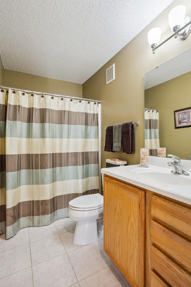 bathroom featuring visible vents, a textured ceiling, toilet, and vanity