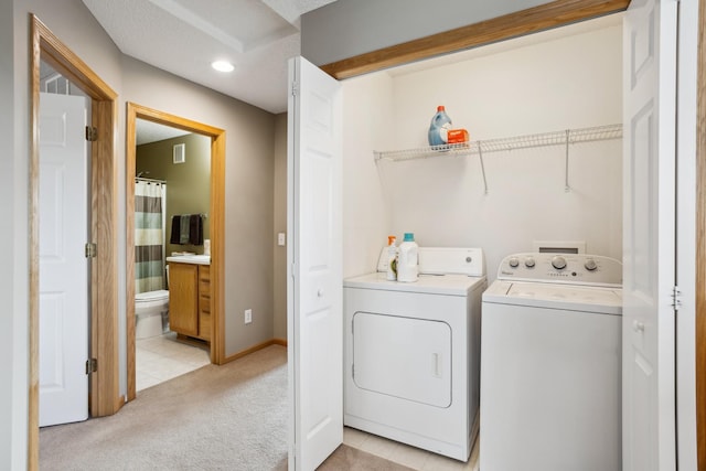 clothes washing area featuring laundry area, visible vents, light tile patterned floors, separate washer and dryer, and light carpet