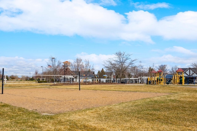 view of home's community featuring playground community, a yard, and volleyball court