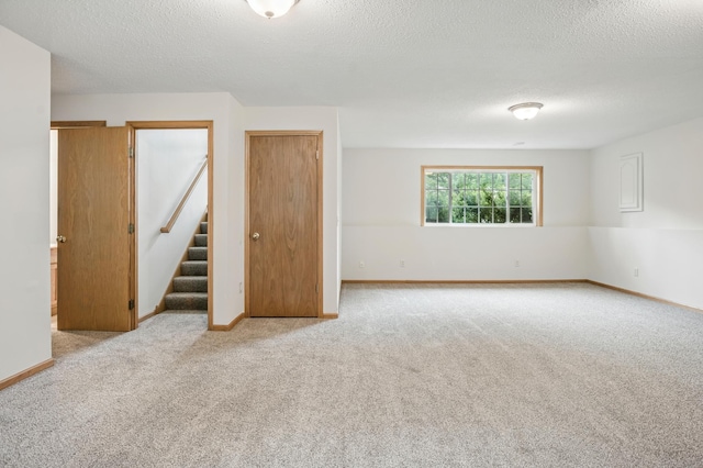 10310 Kaitlin Ave, Hanover, MN 55341 - empty room with carpet, stairs, a textured ceiling, and baseboards