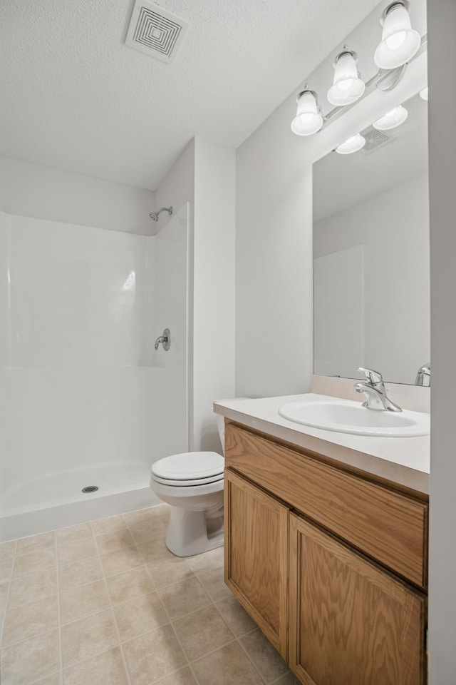 10310 Kaitlin Ave, Hanover, MN 55341 - full bath featuring vanity, a shower, toilet, a textured ceiling, and tile patterned floors