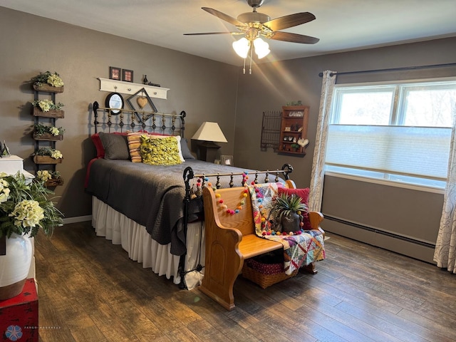 bedroom featuring baseboard heating, hardwood / wood-style flooring, and ceiling fan