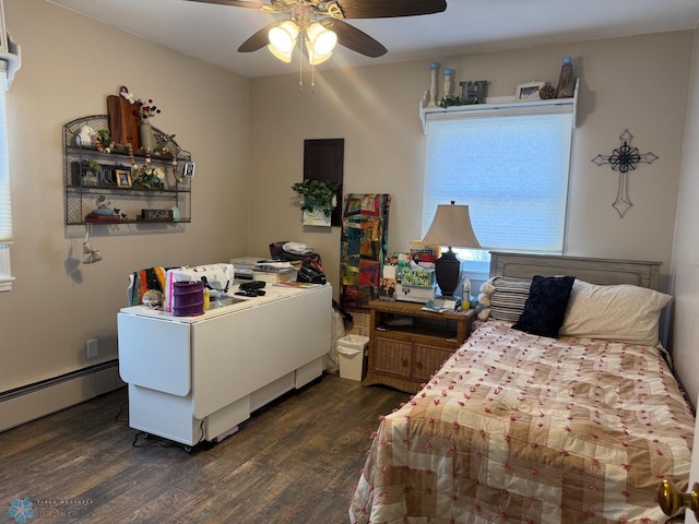 bedroom with dark wood-type flooring, baseboard heating, and a ceiling fan