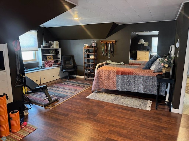 bedroom featuring vaulted ceiling and wood finished floors