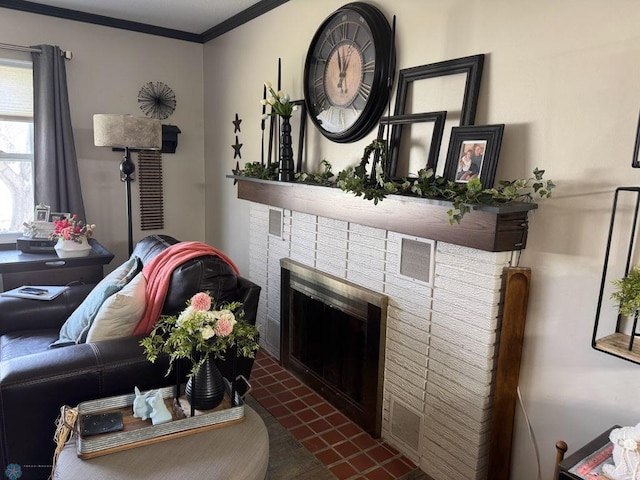 living area featuring crown molding, a tiled fireplace, and visible vents