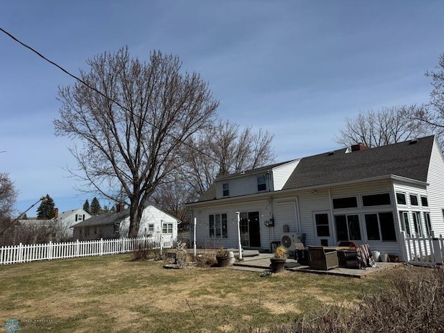 back of house featuring a patio, a yard, and fence
