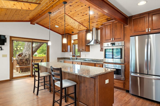 2700 Edgewood Ave S, Saint Louis Park, MN 55426 - kitchen featuring appliances with stainless steel finishes, wall chimney range hood, wood finished floors, stone counters, and a sink