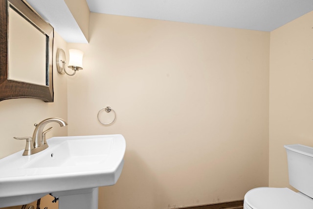 2700 Edgewood Ave S, Saint Louis Park, MN 55426 - half bathroom featuring a sink, toilet, and wood finished floors
