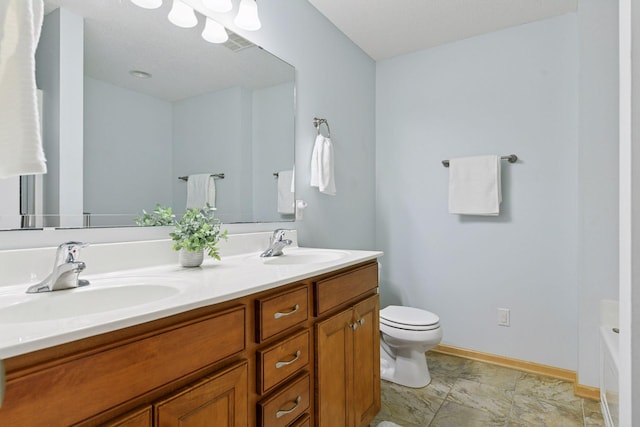 bathroom with a sink, toilet, a washtub, and baseboards