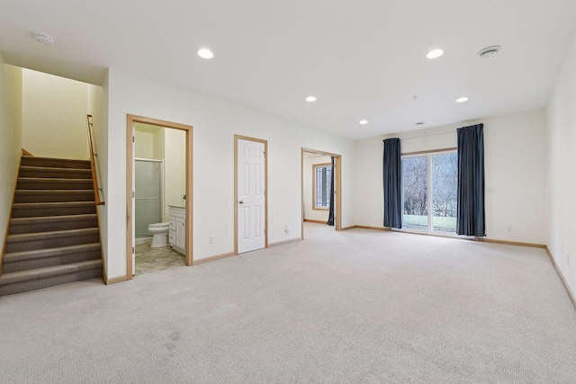 interior space with carpet flooring, baseboards, stairs, and recessed lighting