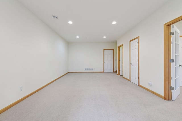 empty room with light carpet, baseboards, visible vents, and recessed lighting