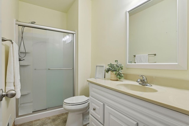 full bathroom with tile patterned floors, toilet, a stall shower, and vanity
