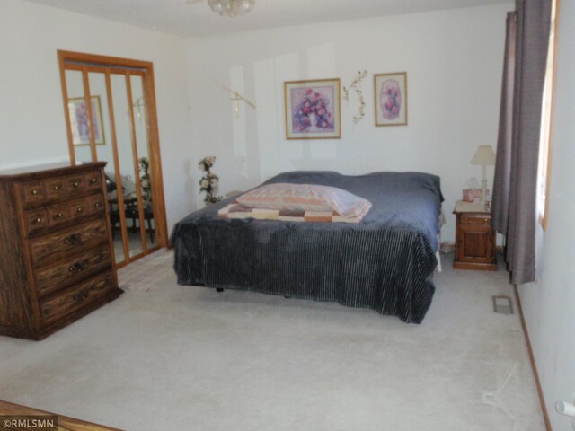 bedroom featuring light colored carpet