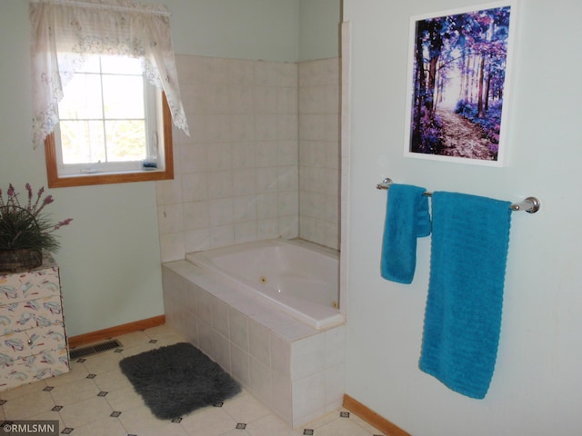 full bathroom featuring baseboards, a jetted tub, and tile patterned flooring
