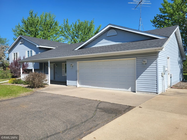 view of front facade with roof with shingles, driveway, a garage, and a porch