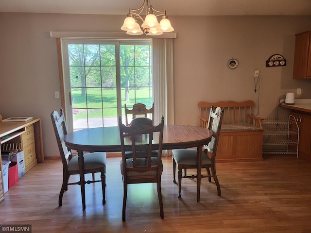 dining space with a chandelier and light wood-style flooring