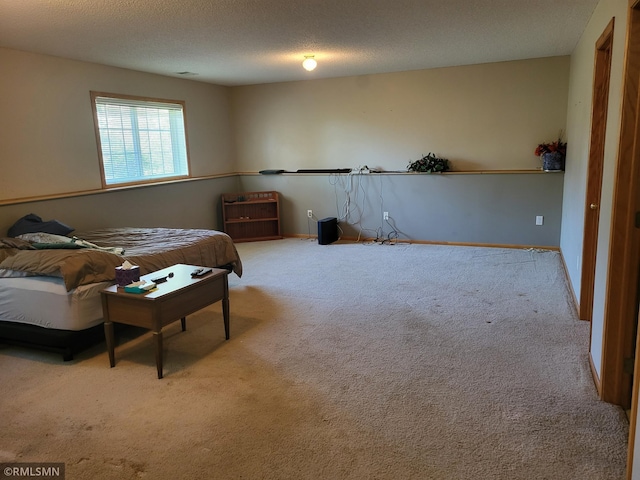 carpeted bedroom featuring a textured ceiling and baseboards