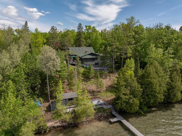 drone / aerial view with a wooded view