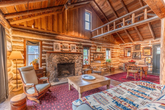 living area featuring beamed ceiling, wooden ceiling, hardwood / wood-style flooring, and a fireplace