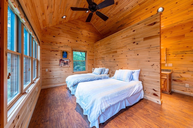 bedroom featuring wooden walls, light wood-style flooring, wooden ceiling, and ceiling fan