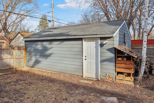 view of outbuilding featuring an outbuilding and fence