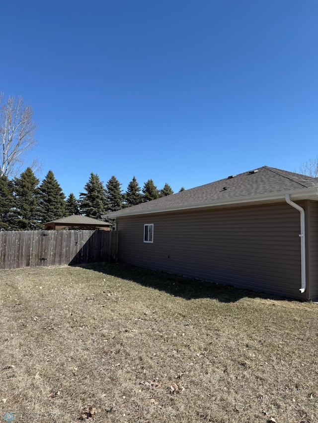 view of side of property featuring fence