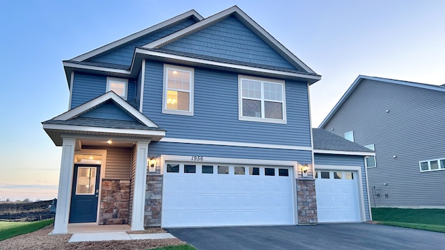 17026 Draper Way, Lakeville, MN 55044 - craftsman inspired home with an attached garage, stone siding, aphalt driveway, and roof with shingles