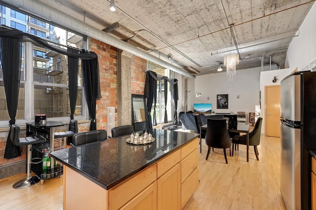 521 7th St Unit 311, Minneapolis, MN 55415 - kitchen featuring freestanding refrigerator, a wealth of natural light, light wood finished floors, and open floor plan