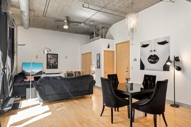 521 7th St Unit 311, Minneapolis, MN 55415 - dining room featuring wood finished floors and a towering ceiling