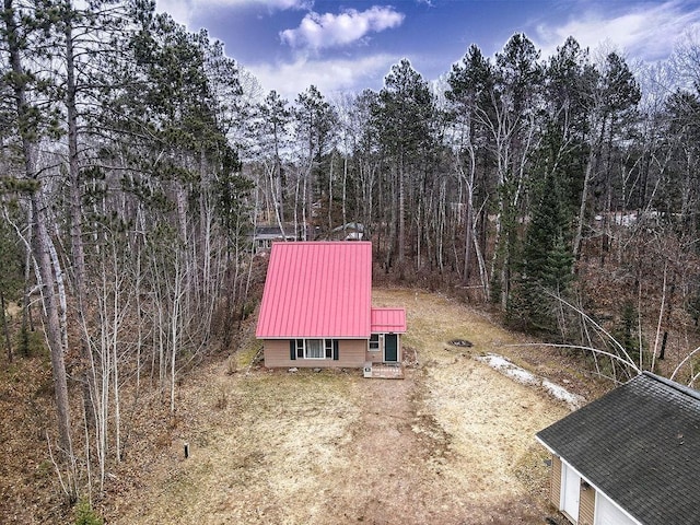 drone / aerial view featuring a wooded view