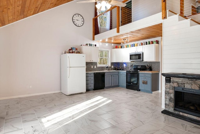 kitchen with a sink, backsplash, black appliances, and marble finish floor