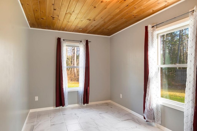 spare room with crown molding, baseboards, wood ceiling, and marble finish floor