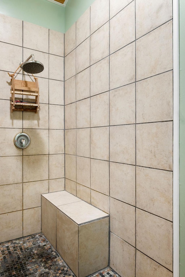 full bath featuring a tile shower