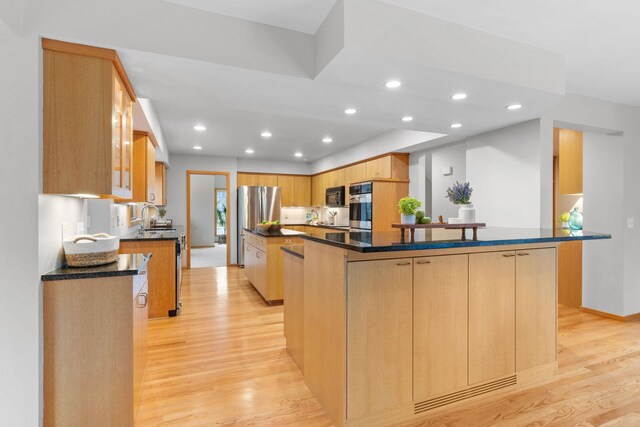 kitchen with recessed lighting, a sink, light wood-style flooring, and appliances with stainless steel finishes