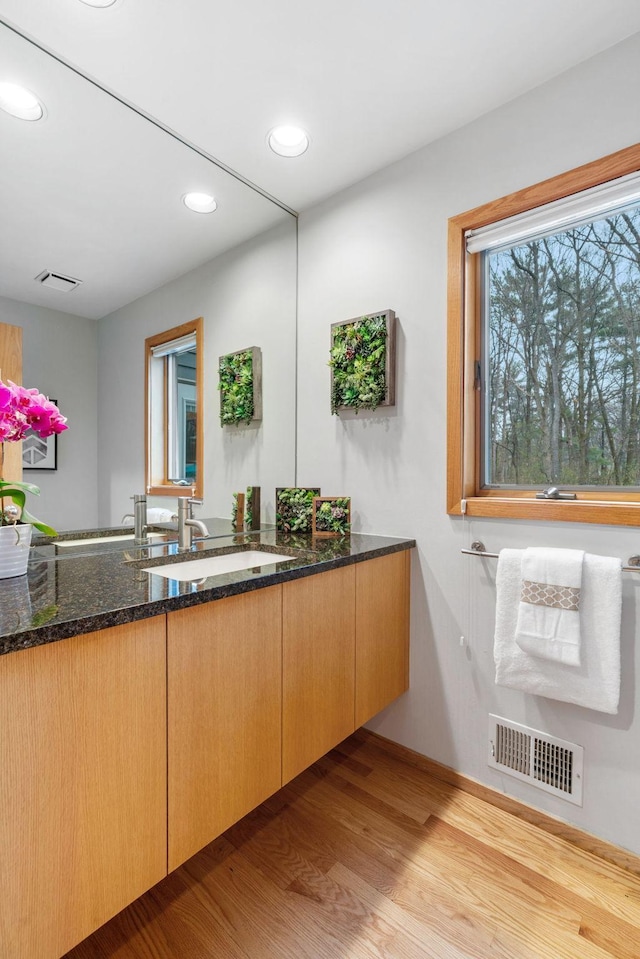 bathroom featuring visible vents, recessed lighting, wood finished floors, and vanity