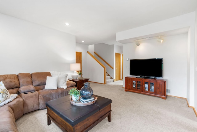 living room featuring track lighting, baseboards, stairway, light colored carpet, and recessed lighting