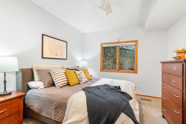 carpeted bedroom featuring visible vents and baseboards