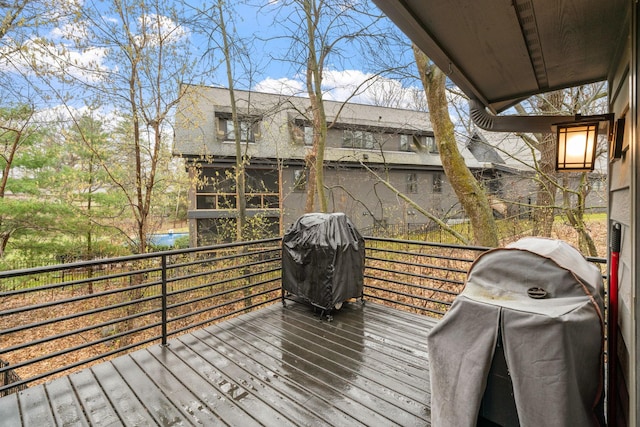 wooden deck featuring a grill