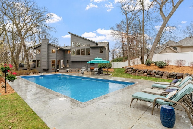 view of swimming pool featuring a patio, a fenced in pool, and a fenced backyard