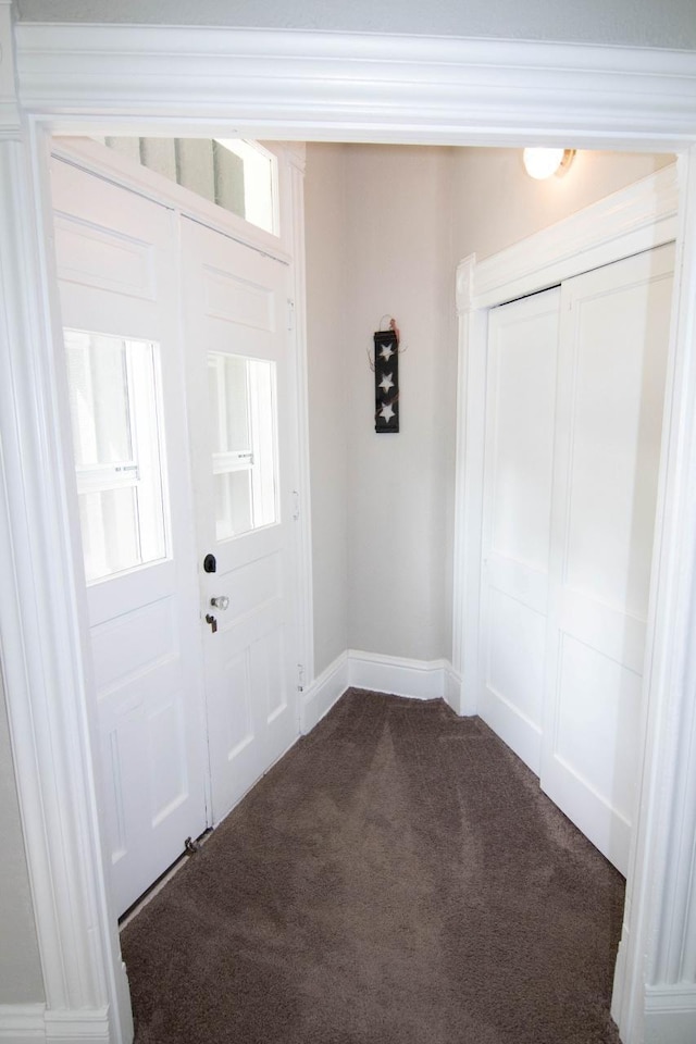 217 Center St, Mankato, MN 56001 - foyer featuring baseboards and dark colored carpet